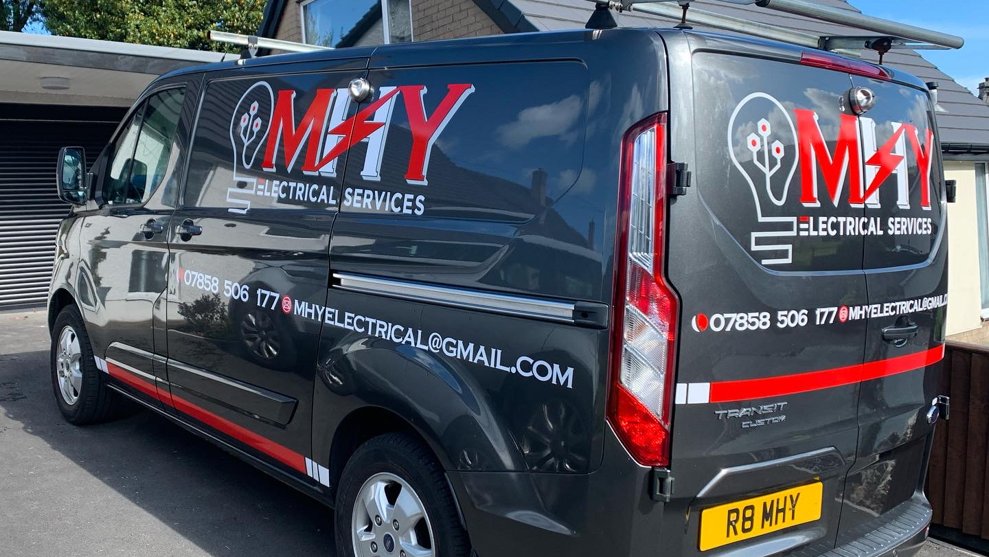 The MHY Electrical Services van parked on a driveway, phone number and email on the side