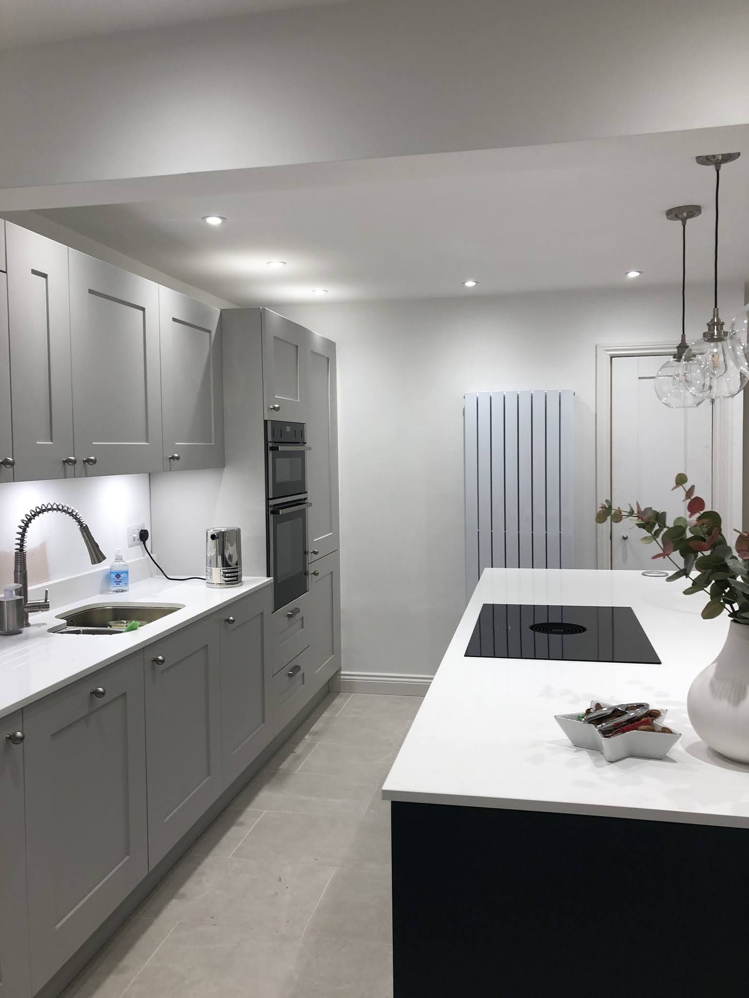 Kitchen wall units with under-cabinet strip lighting and a built-in oven