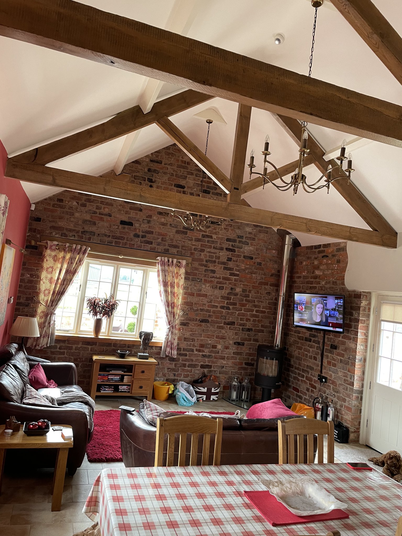 A beamed cottage living room with new pendant and wall lighting