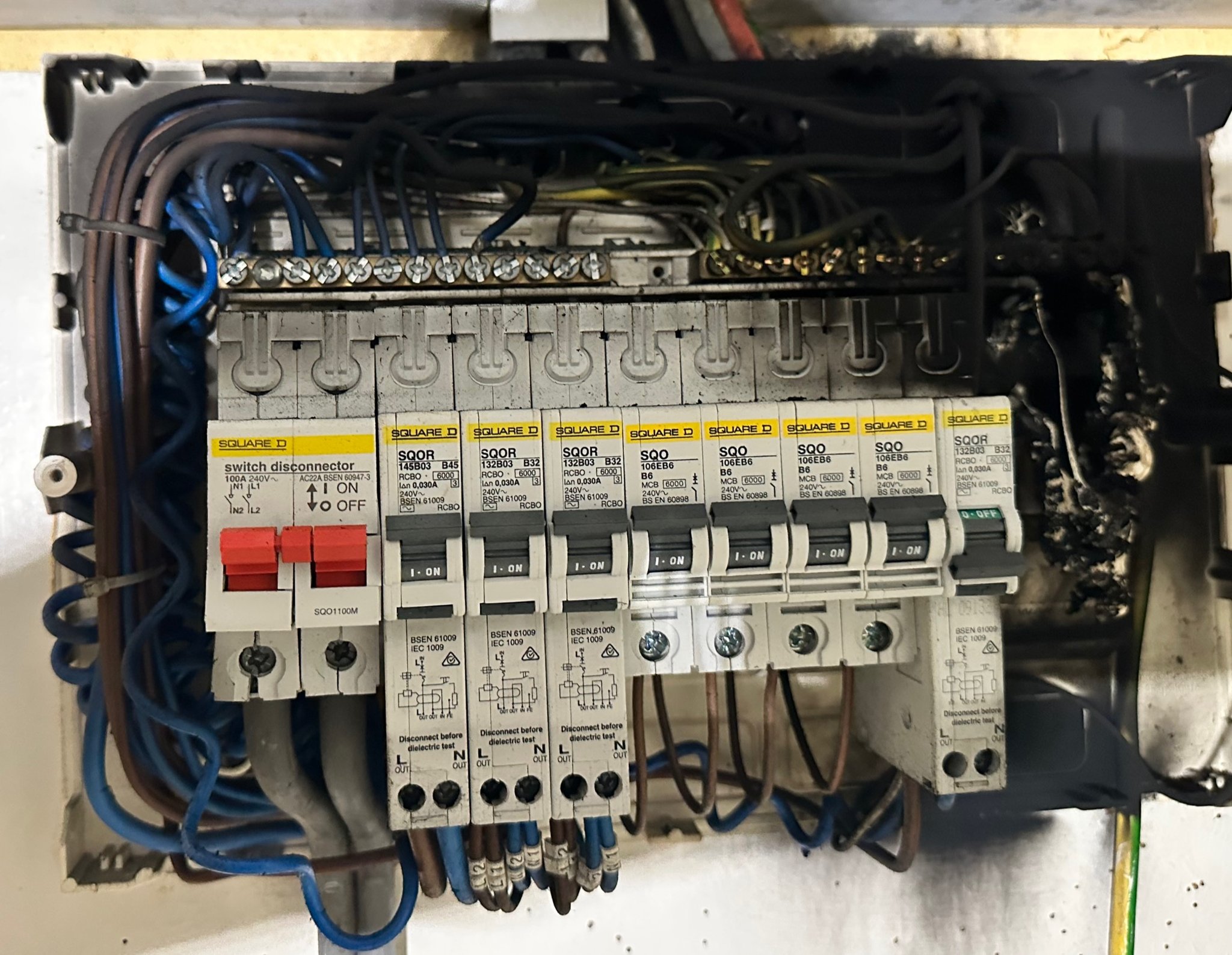 A fire-damaged fuse board, scorched and blackened, found on an emergency callout
