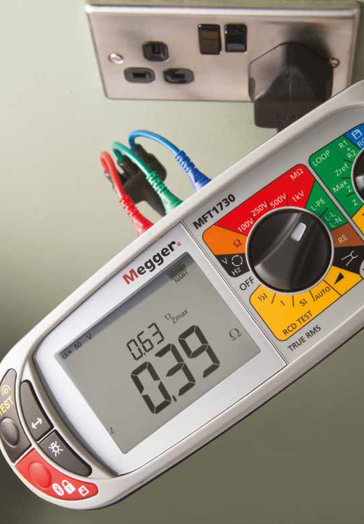 A Megger multifunction tester plugged into a socket during an inspection