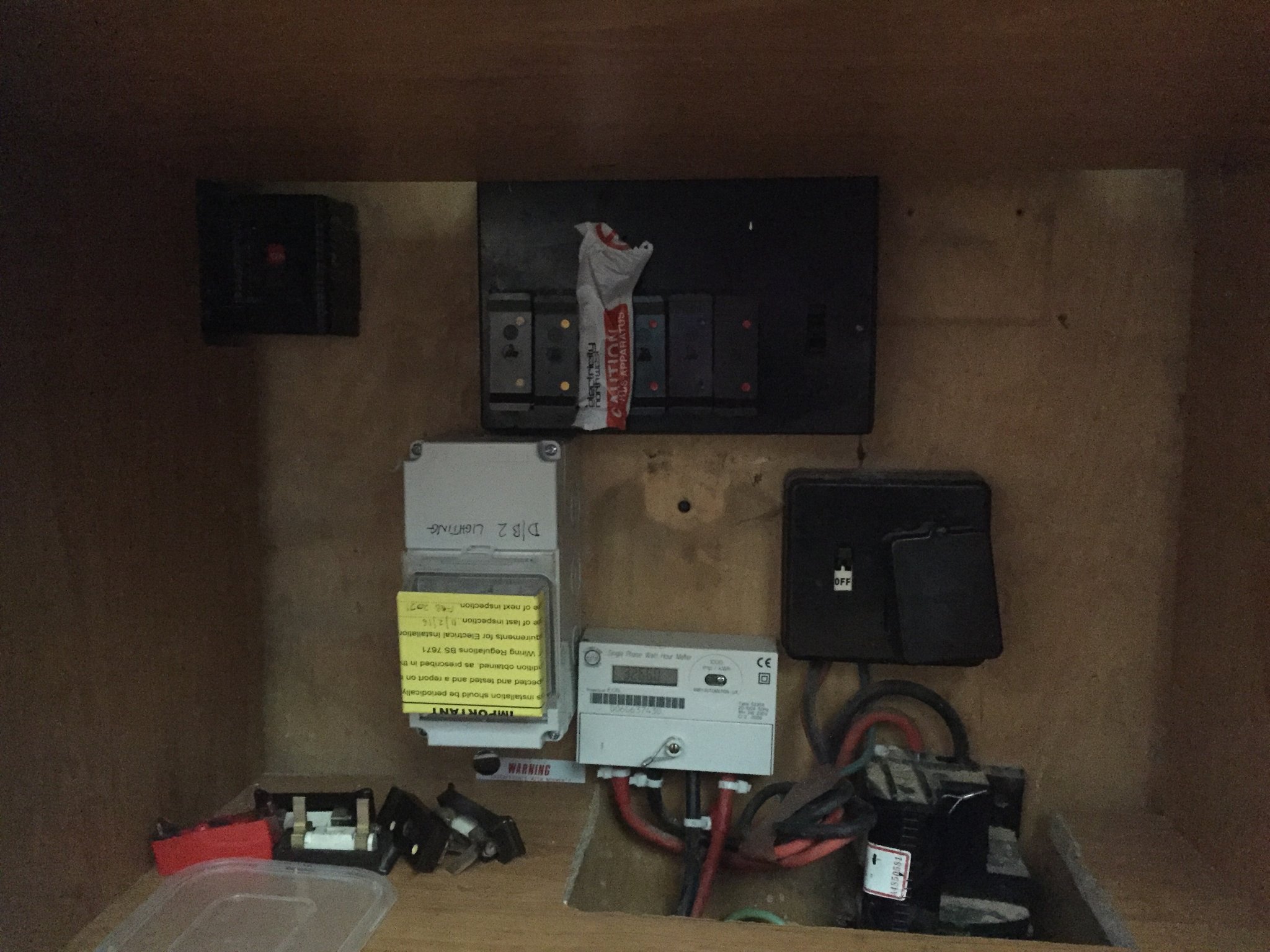 An old fuse board and meter in a cupboard before replacement