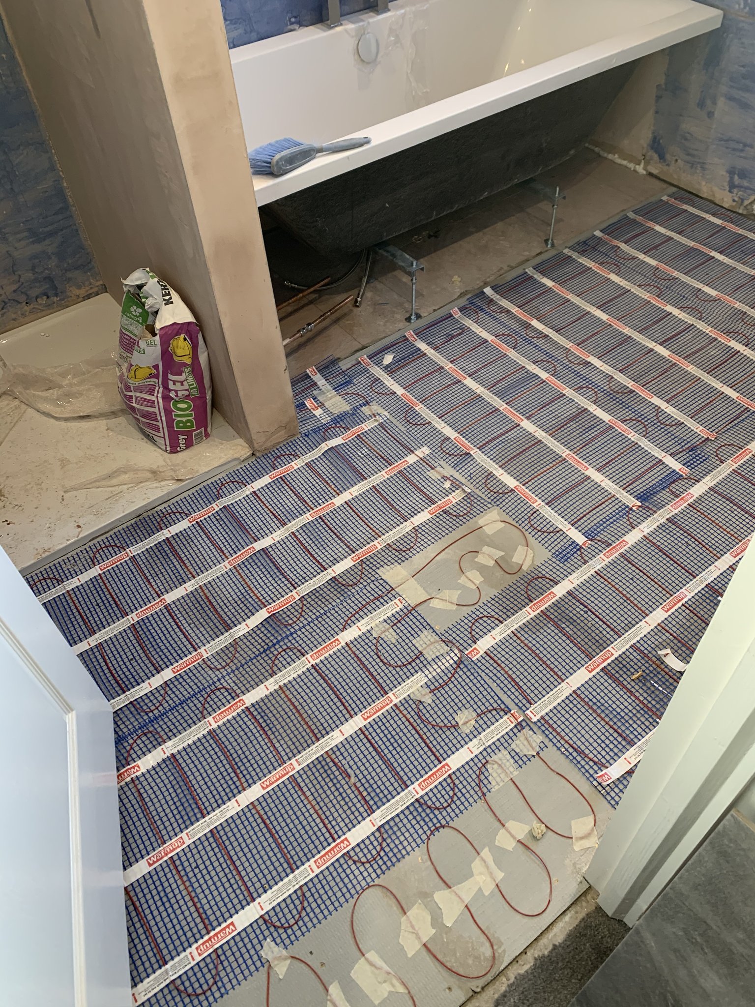 An underfloor heating mat being laid